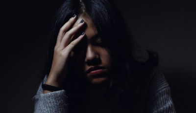 Woman crying while she's struggling with surviving divorce.