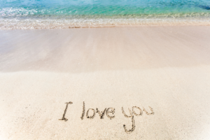 I love you written in the sand at the beach