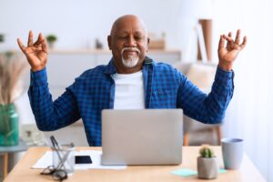 Happy man meditating in front of a laptop about How To Have A Better Life After Divorce Than When Married