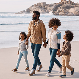 Family of four, father, mother, daughter, son, walking together alng